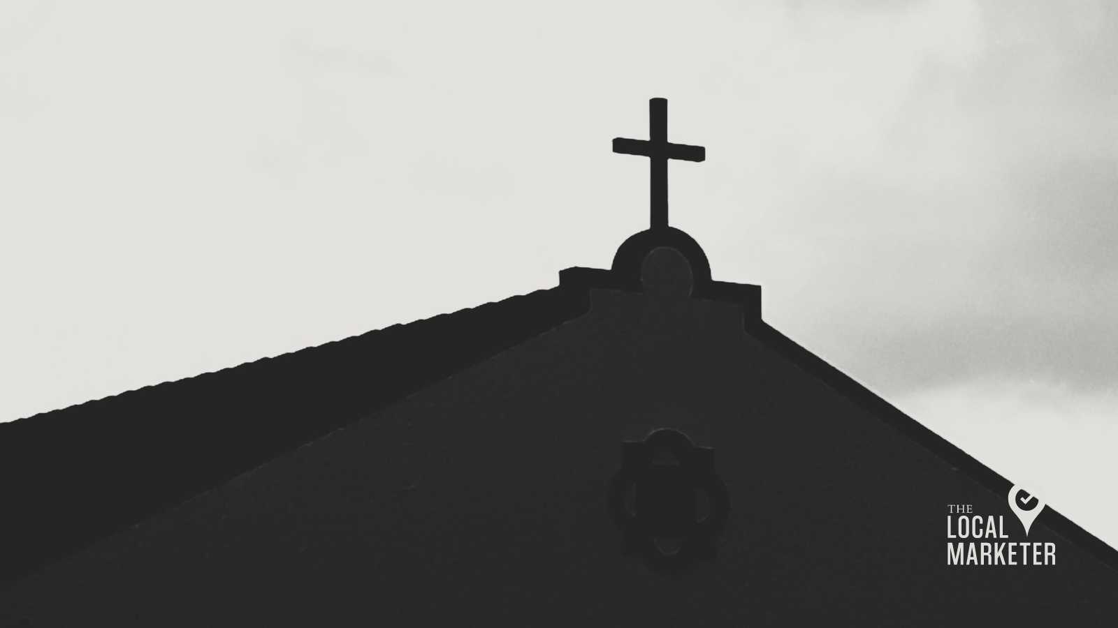 Silhouette of a church roof with a cross against a cloudy sky, representing the importance of church presence and outreach in the digital age.